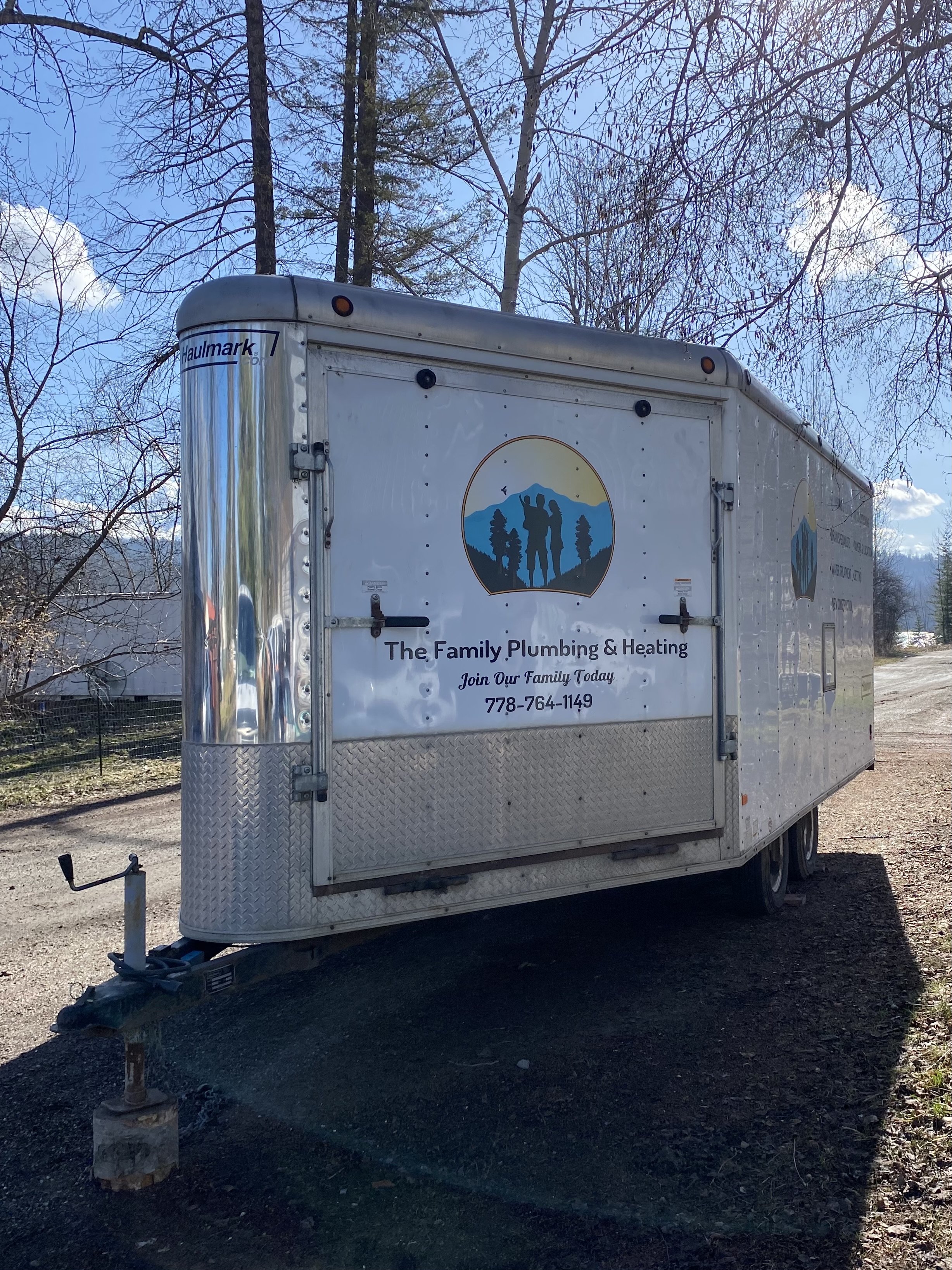 The Family Plumbing and Heating trailer parked with the logo visible